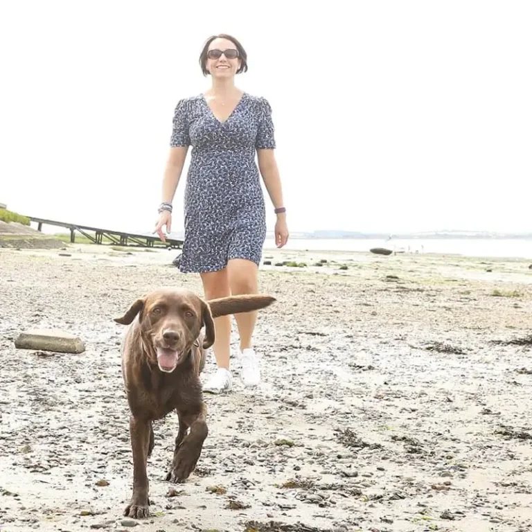 Sarah and her dog on the beach